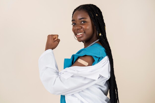 female-doctor-showing-arm-with-sticker-after-getting-vaccine