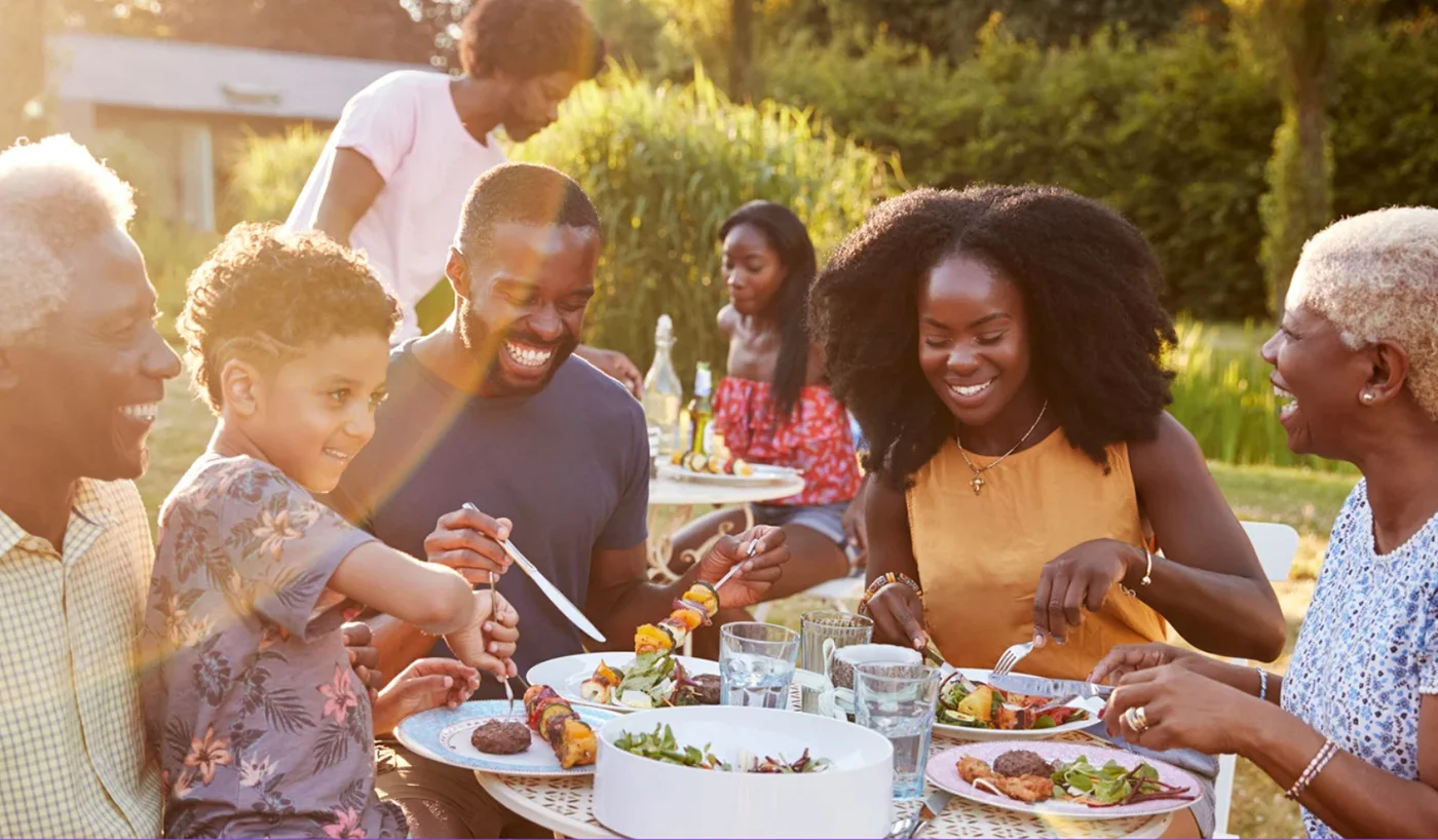 happy-black-family-dining-outside